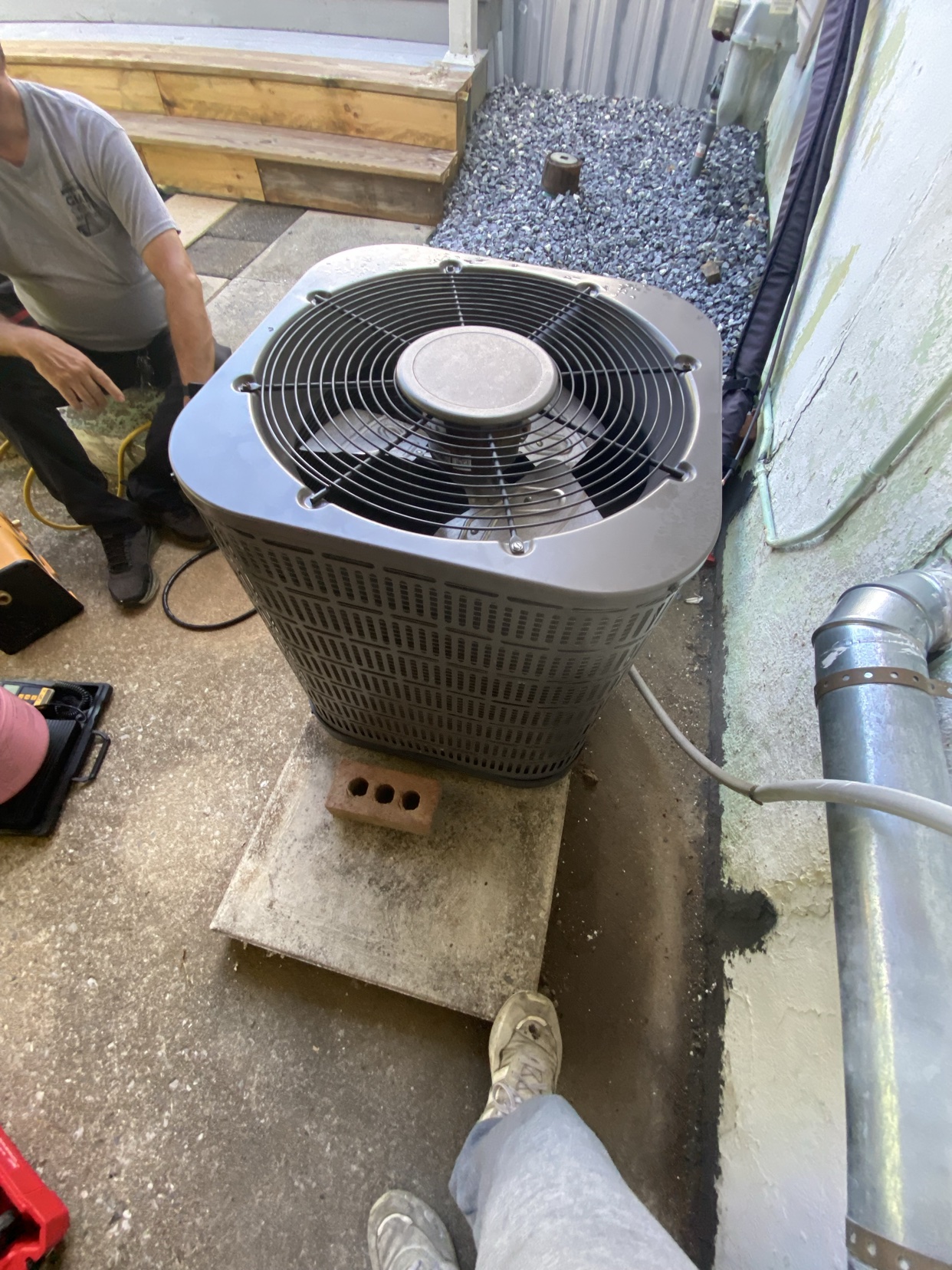 AC condenser install, tech on site
